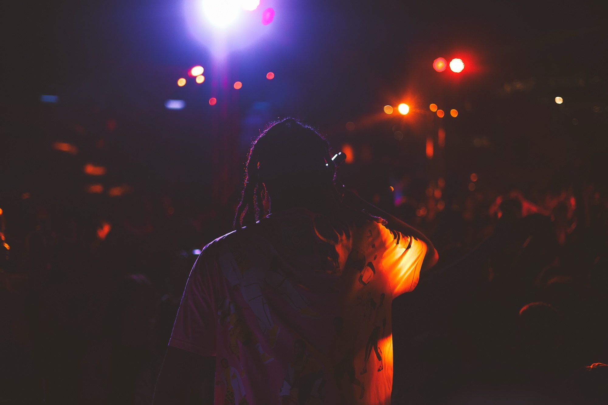 Artist performing under stage lighting at an LSL production